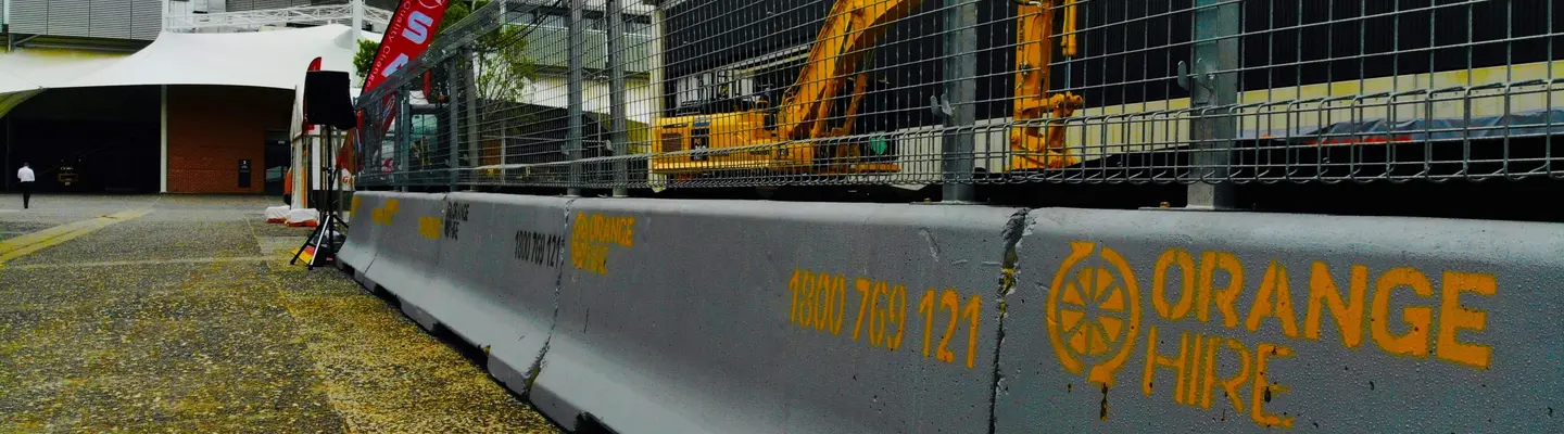 Safety barriers set up at a construction site to protect workers, manage traffic flow, and secure the work zone.