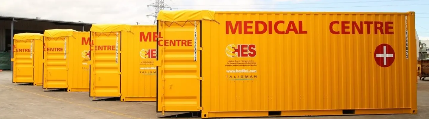 Stacked storage containers at a construction or logistics site, organized and ready for deployment or repurposing.